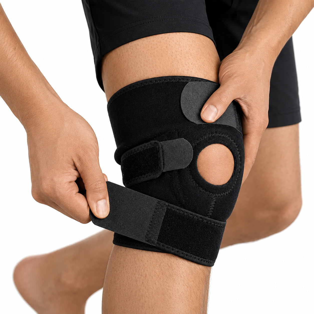 Une personne ajuste une genouillère réglable à rotule ouverte pour un soutien, une compression et une stabilité supplémentaires.