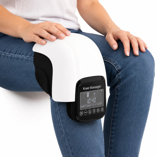 Knämassage med värme och vibration som används sittande för stöd och avslappning av knäleden.